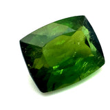 A cushion-cut green tourmaline gemstone with faceted edges, showing a rich green color gradient from dark forest green to bright yellow-green.